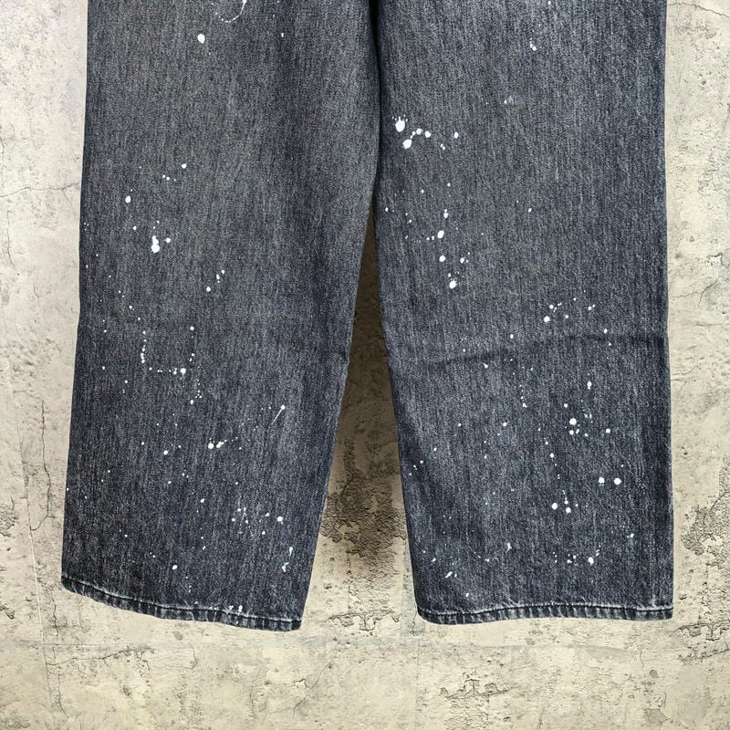 Dark denim pants with white paint-speckle splatter pattern