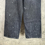 Dark denim pants with white paint-speckle splatter pattern