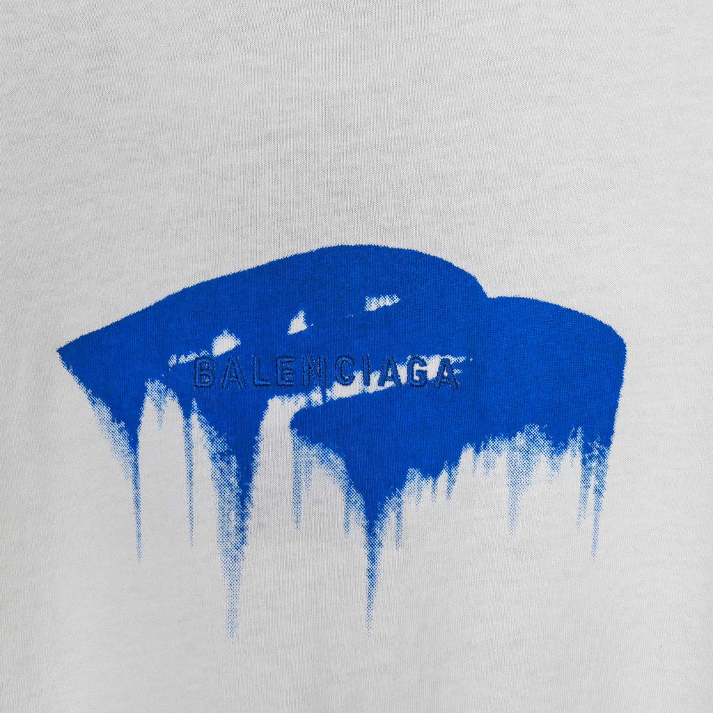 Blue drip graphic with faint text on a white T-shirt
