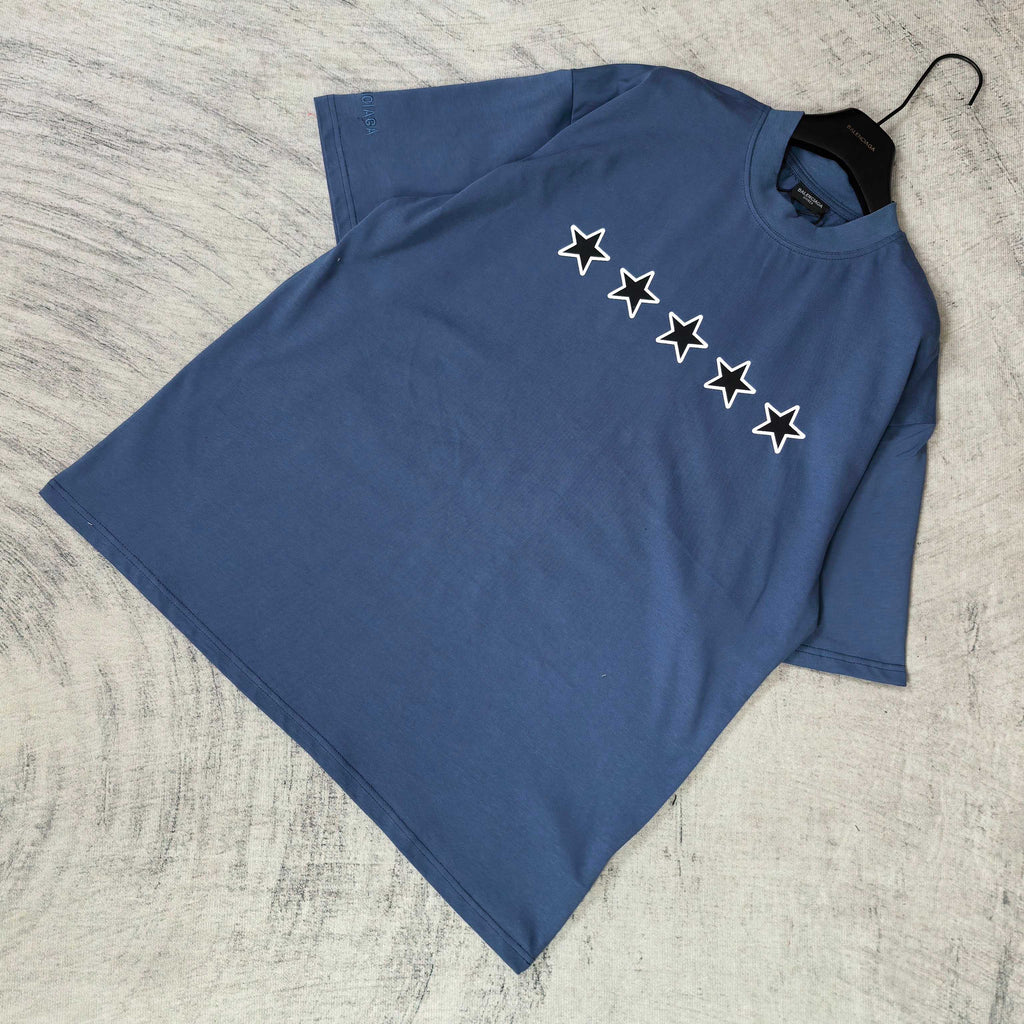 Balenciaga short-sleeve T-shirt, blue, folded; white star graphic on front.