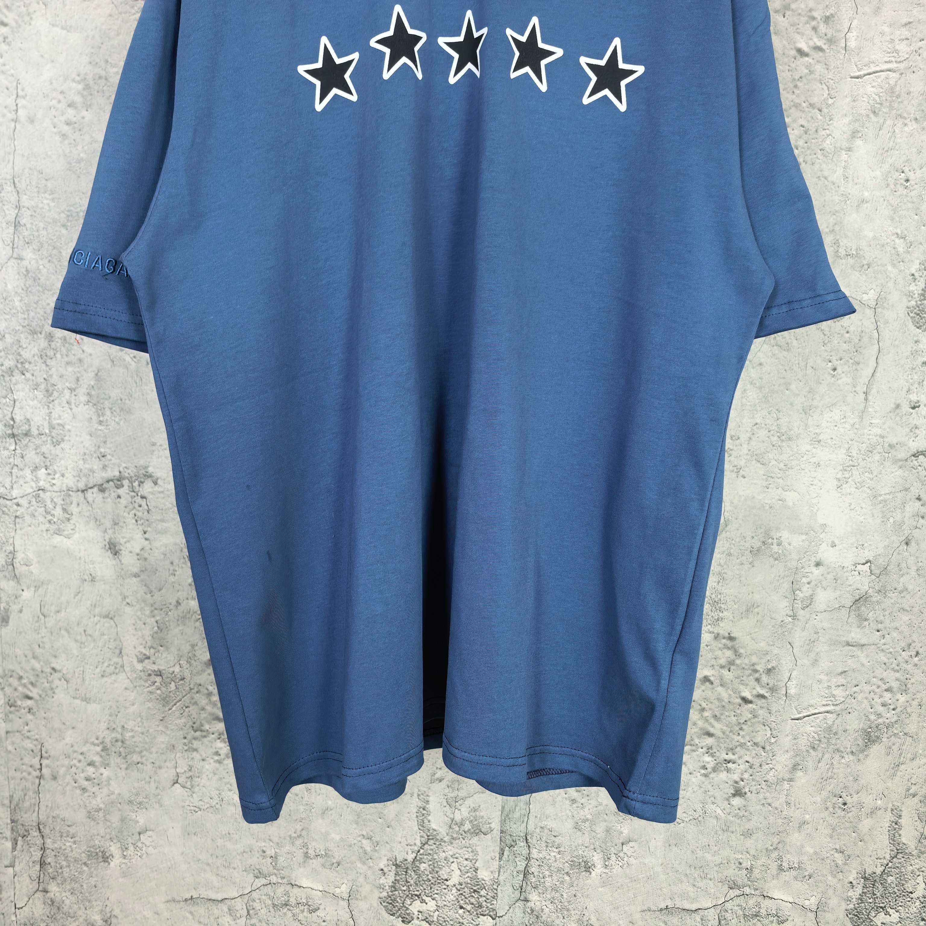 Balenciaga short-sleeve T-shirt, blue; white stars print near neckline, full front view.