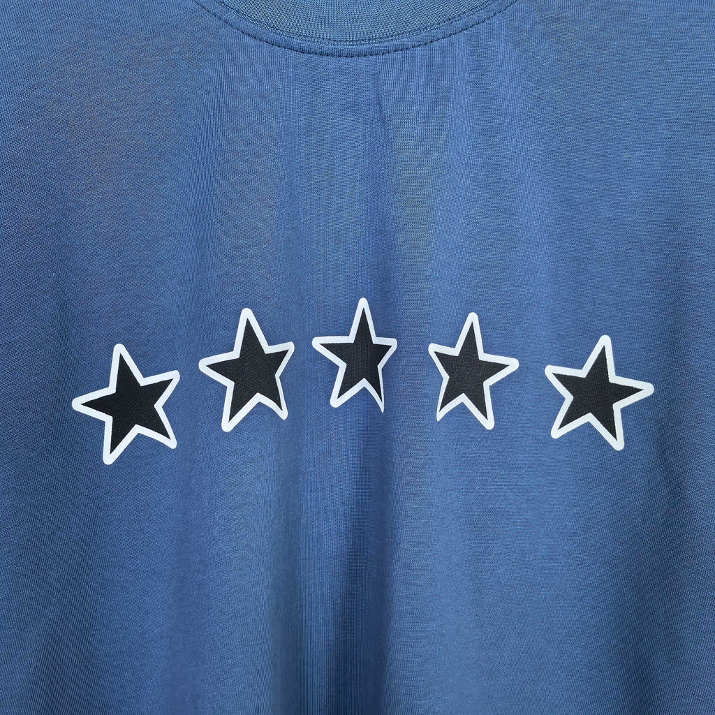 Balenciaga short-sleeve T-shirt detail: white outlined stars print on blue fabric.
