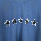 Balenciaga short-sleeve T-shirt detail: white outlined stars print on blue fabric.