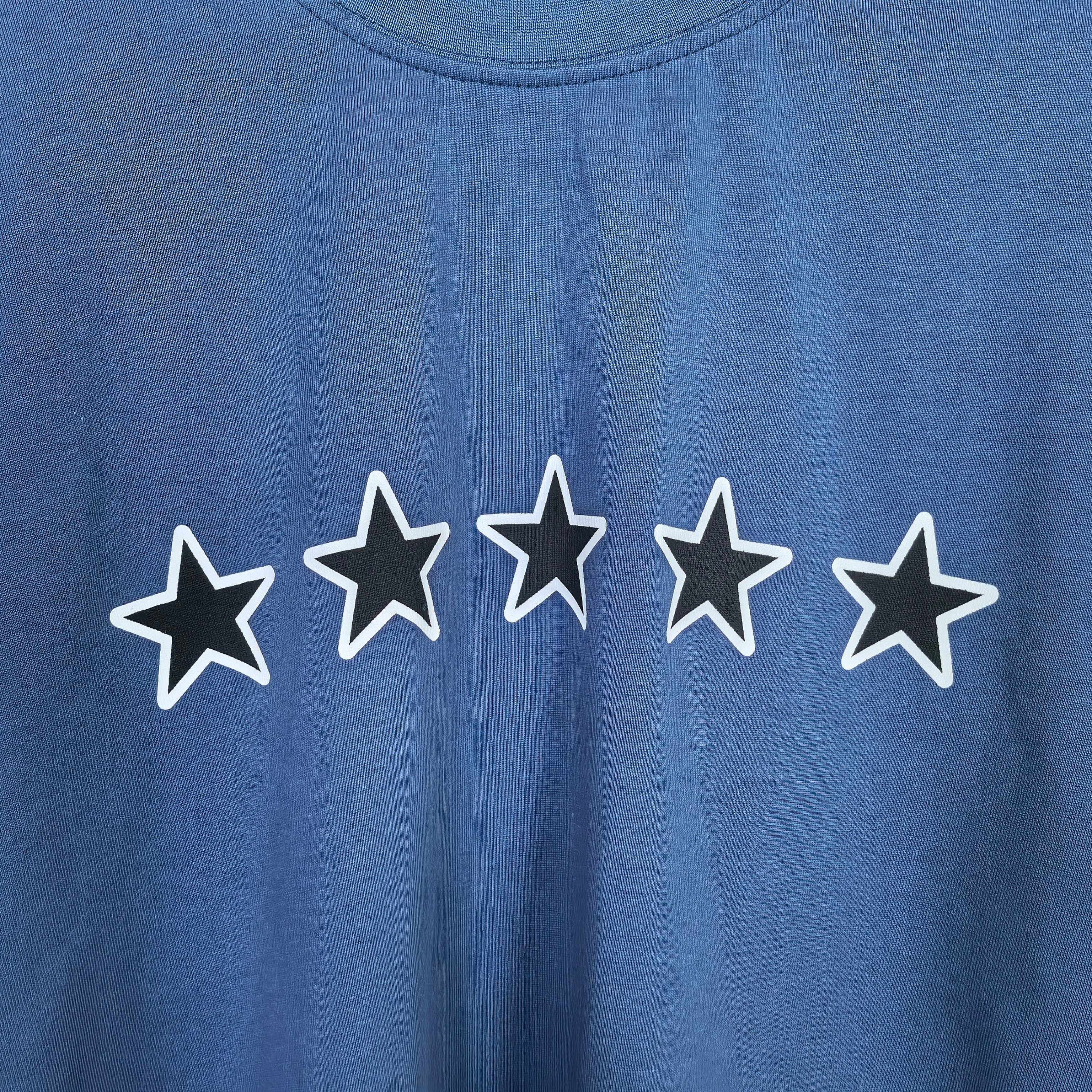 Balenciaga short-sleeve T-shirt detail: white outlined stars print on blue fabric.