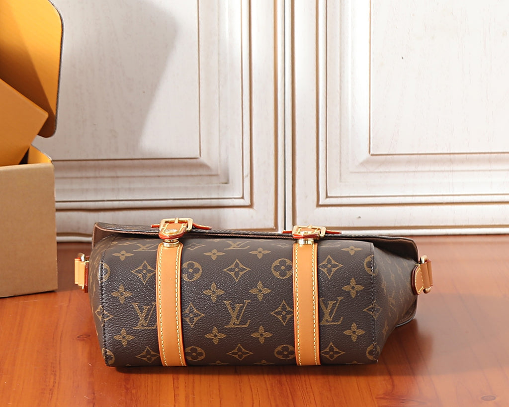 Monogram crossbody bag with tan center strap and gold-tone buckles
