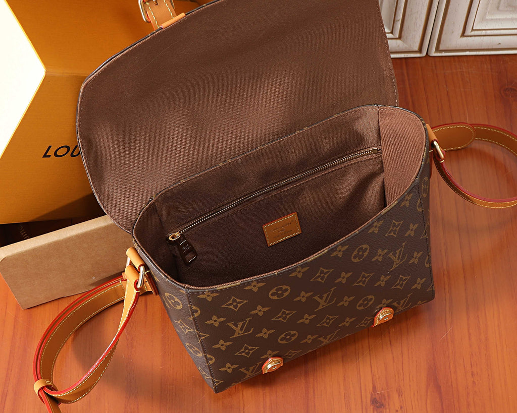 Monogram crossbody bag with open top pocket and tan leather crossbody strap