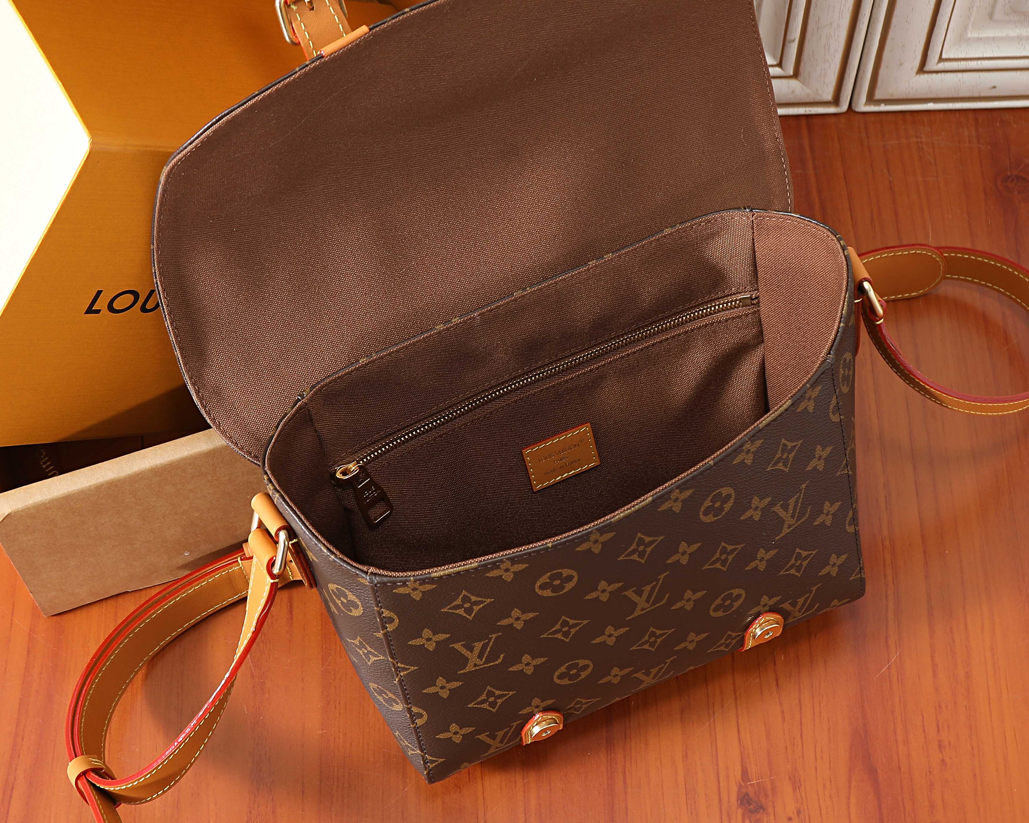 Monogram crossbody bag with open top pocket and tan leather crossbody strap
