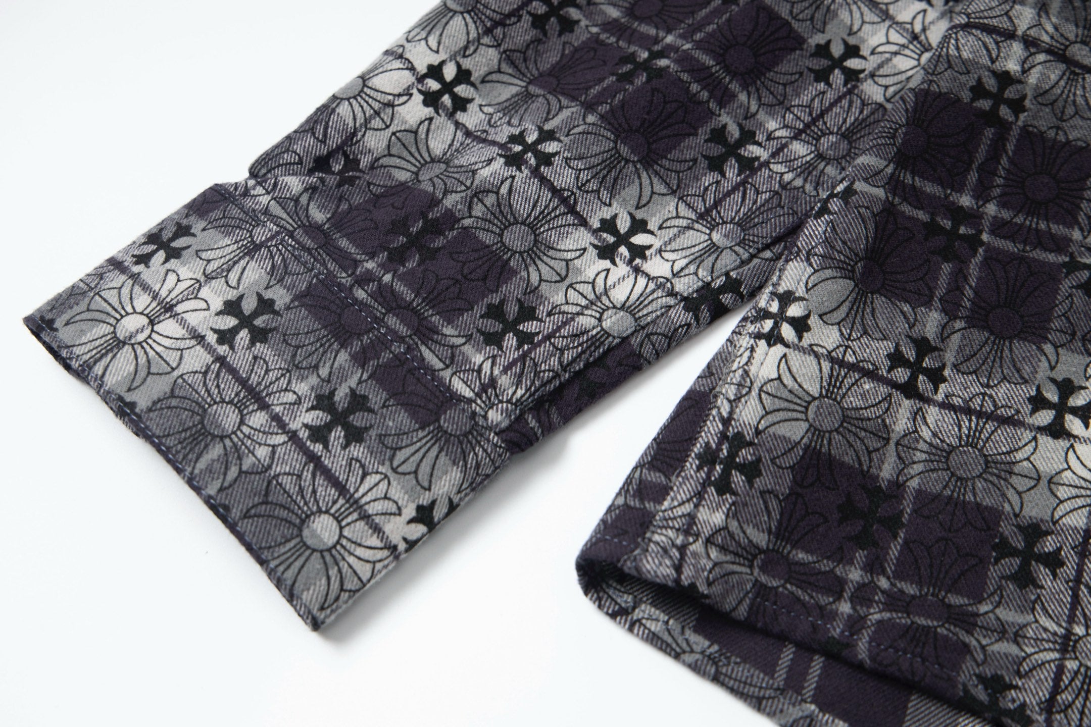 Long-sleeve button-up shirt with patterned cuffs and dark floral-plaid fabric