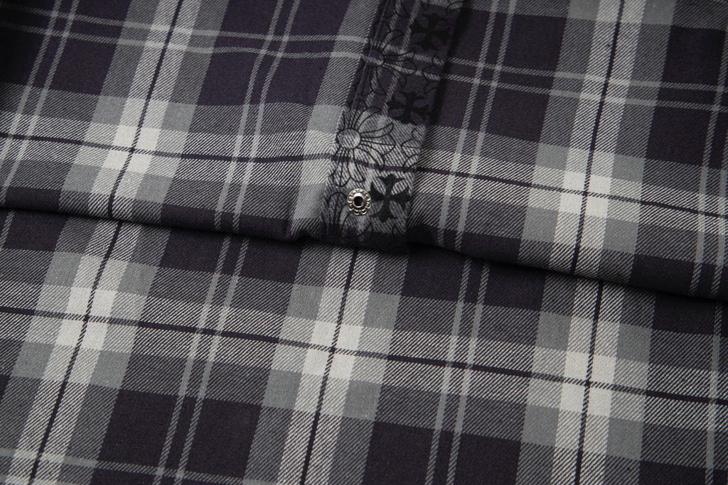 Long-sleeve shirt close-up of plaid panel and small button on placket