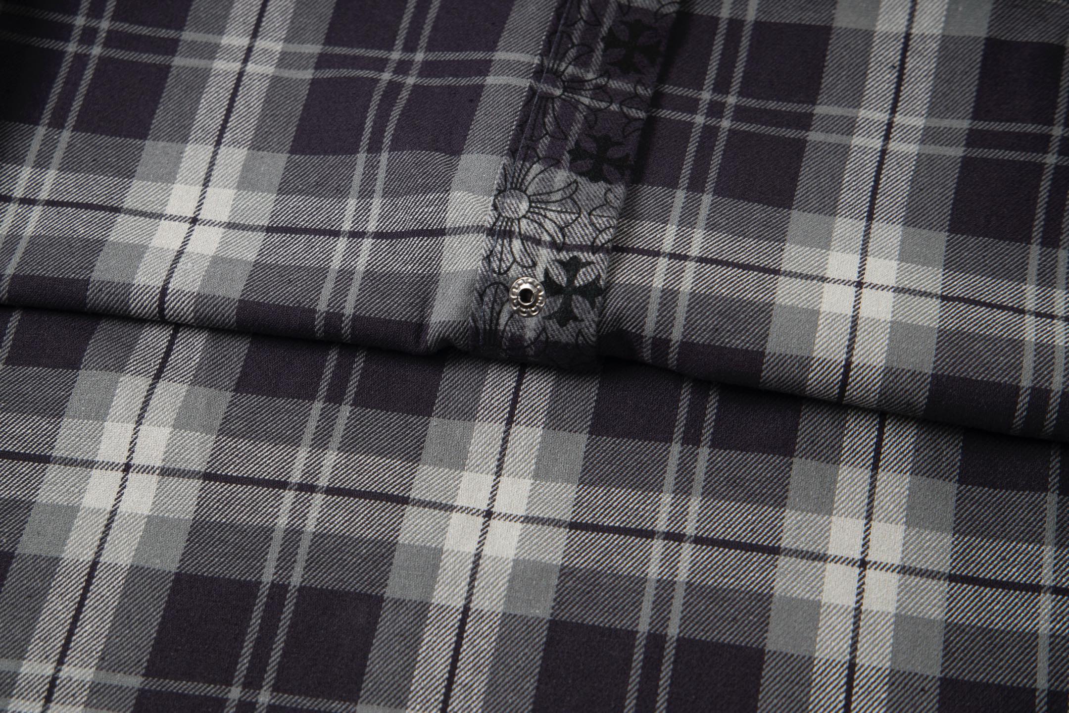 Long-sleeve shirt close-up of plaid panel and small button on placket