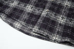 Long-sleeve shirt hem view with dark floral and plaid pattern panel