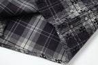 Long-sleeve shirt corner close-up showing plaid panel and floral print
