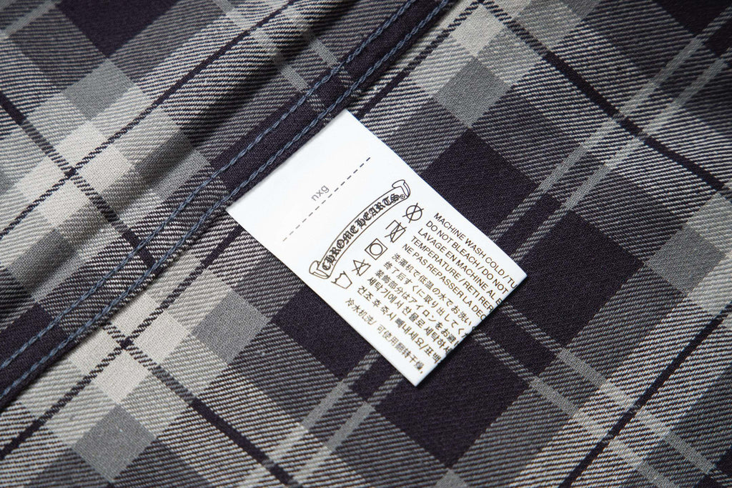 Long plaid fabric garment with stitched hem and care label