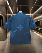 Back view of bright blue short-sleeve shirt with tonal monogram-style motif