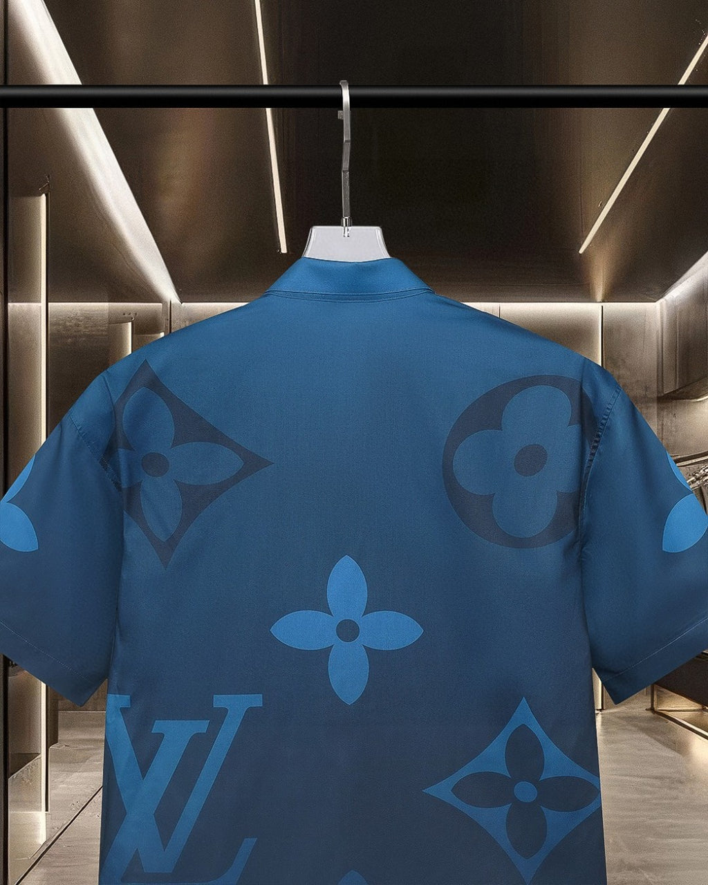 Back view of bright blue short-sleeve shirt with tonal monogram-style motif