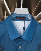 Bright blue short-sleeve shirt with button-front pointed collar and neck logo tag
