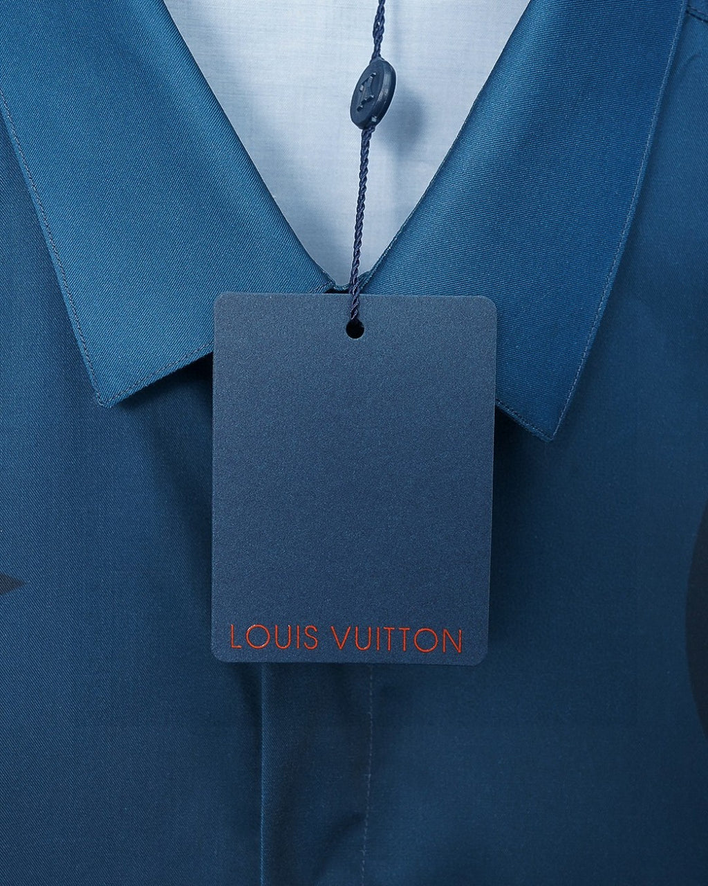 Neckline tag on bright blue short-sleeve shirt with button placket
