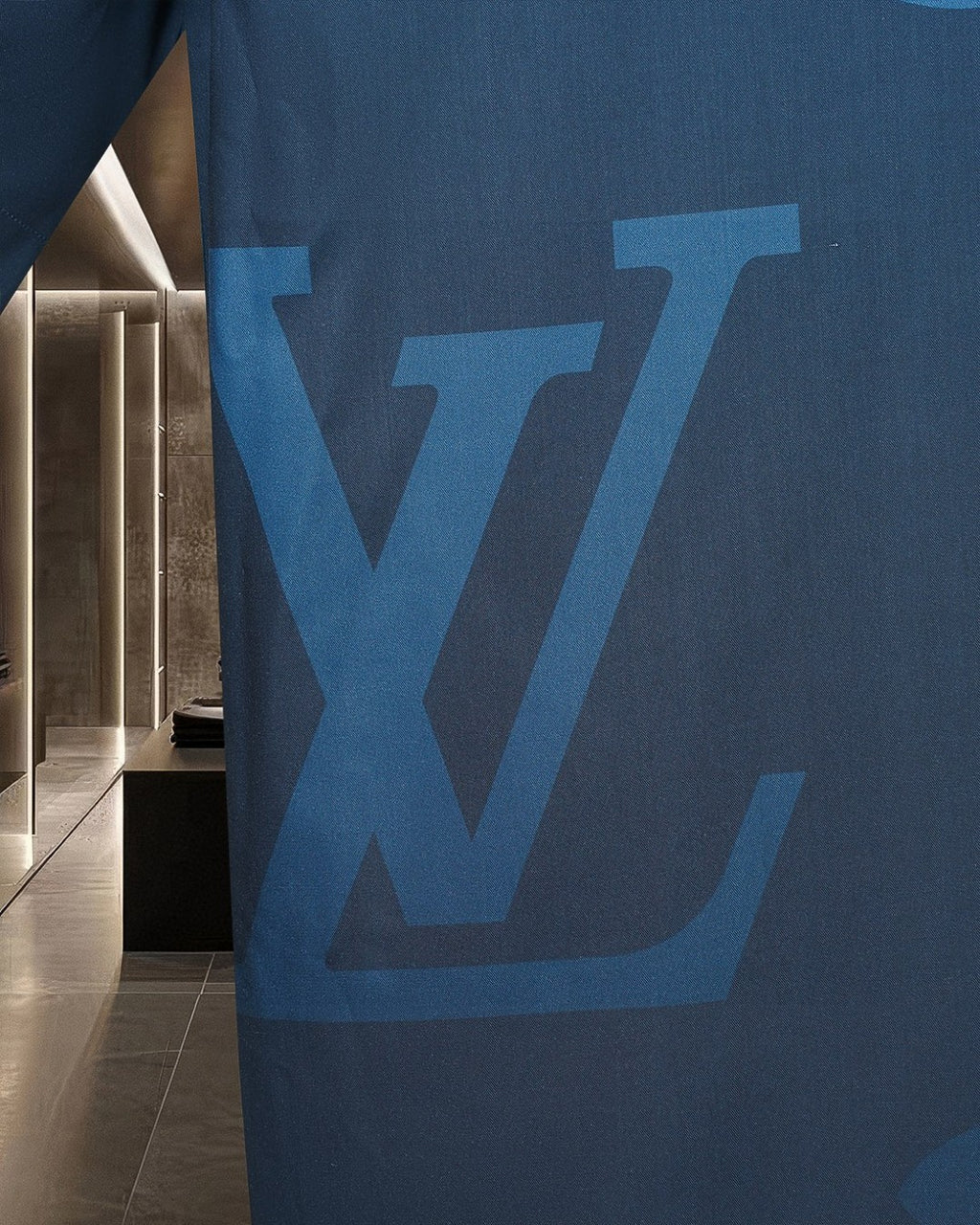 Bright blue short-sleeve shirt with large LV-style monogram graphic