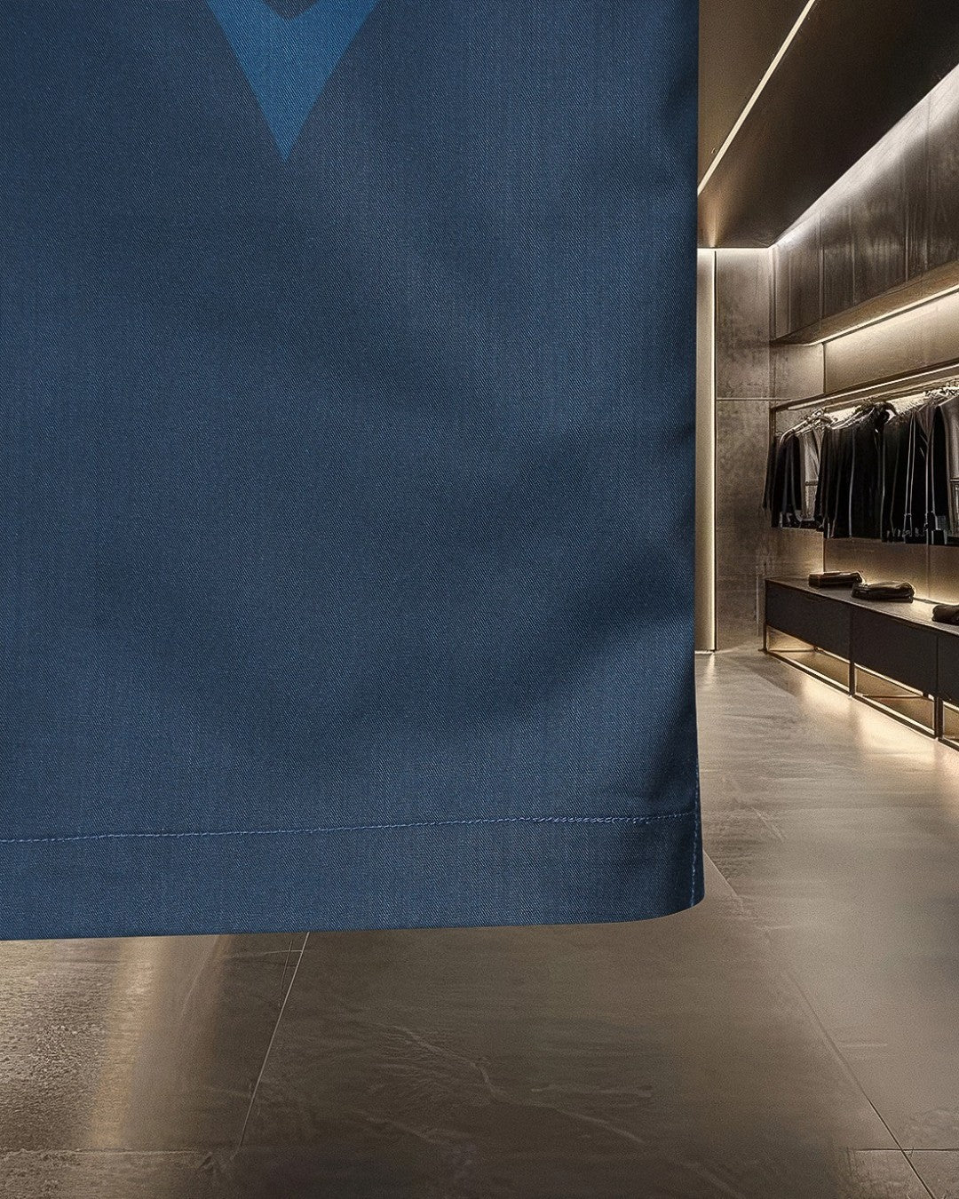 Blue button-up shirt hem with straight bottom edge and side seam