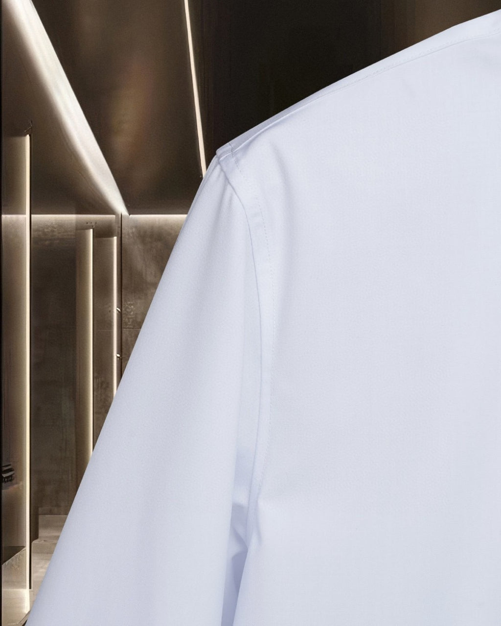 White button-up shirt sleeve and side panel seam