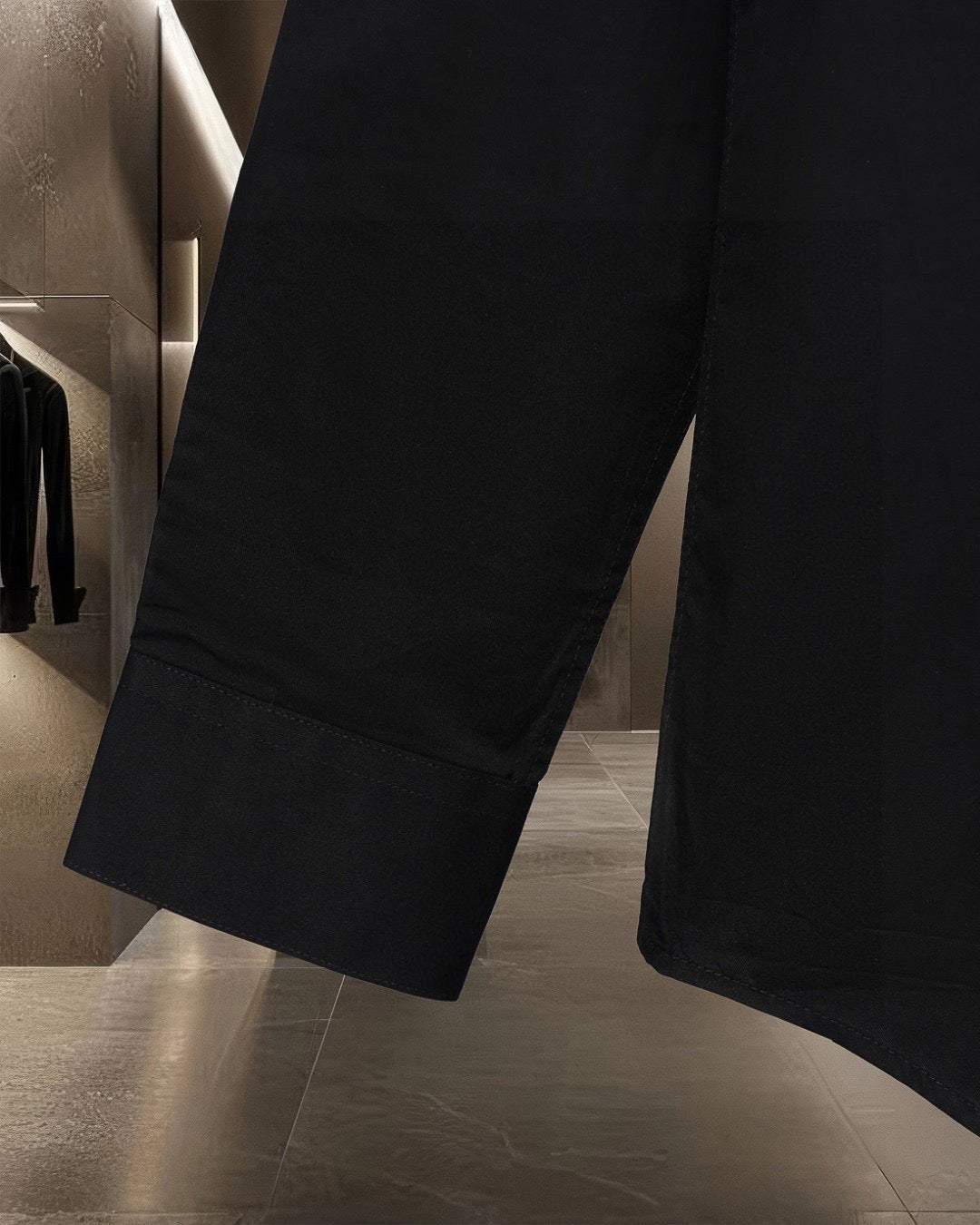 Black long-sleeve shirt lower panel and extended hem seam