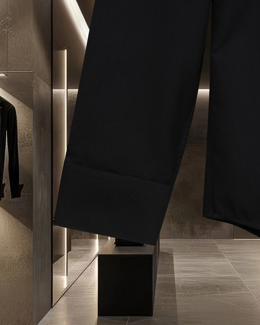 Black long-sleeve shirt lower hem with seam and panel detailing