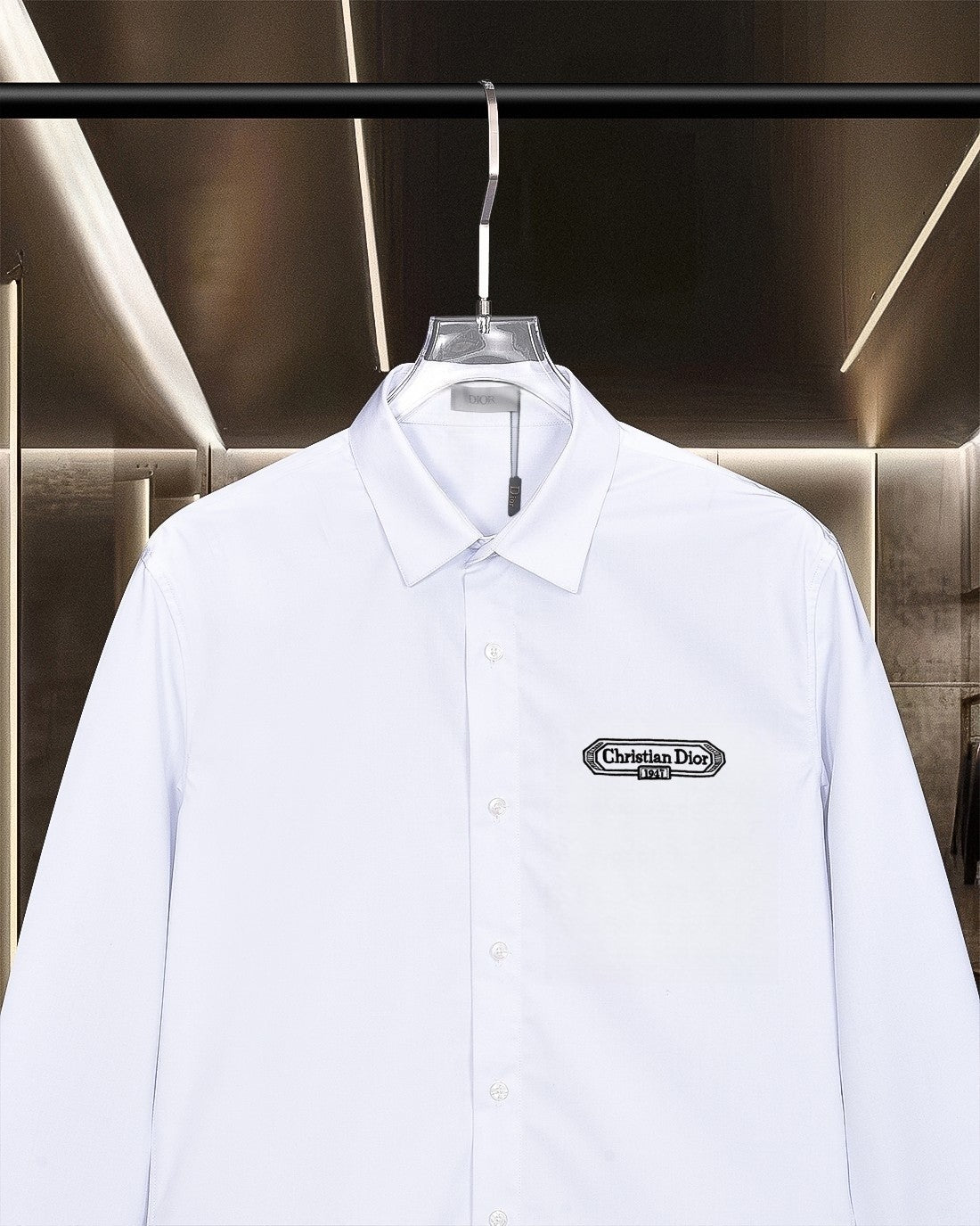 White button-up dress shirt with pointed collar and chest logo patch