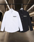 Dior long-sleeve button-up shirts, one white and one dark, with chest logos