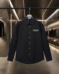 Dior black long-sleeve button-up shirt with pointed collar and chest logo patch