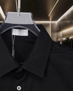 Dior black button-up shirt collar and placket close-up with inner label