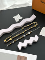Gold and silver beaded charm bracelets arranged on a display stand