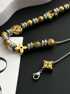Louis Vuitton bead necklace close-up with gold and silver star pendant