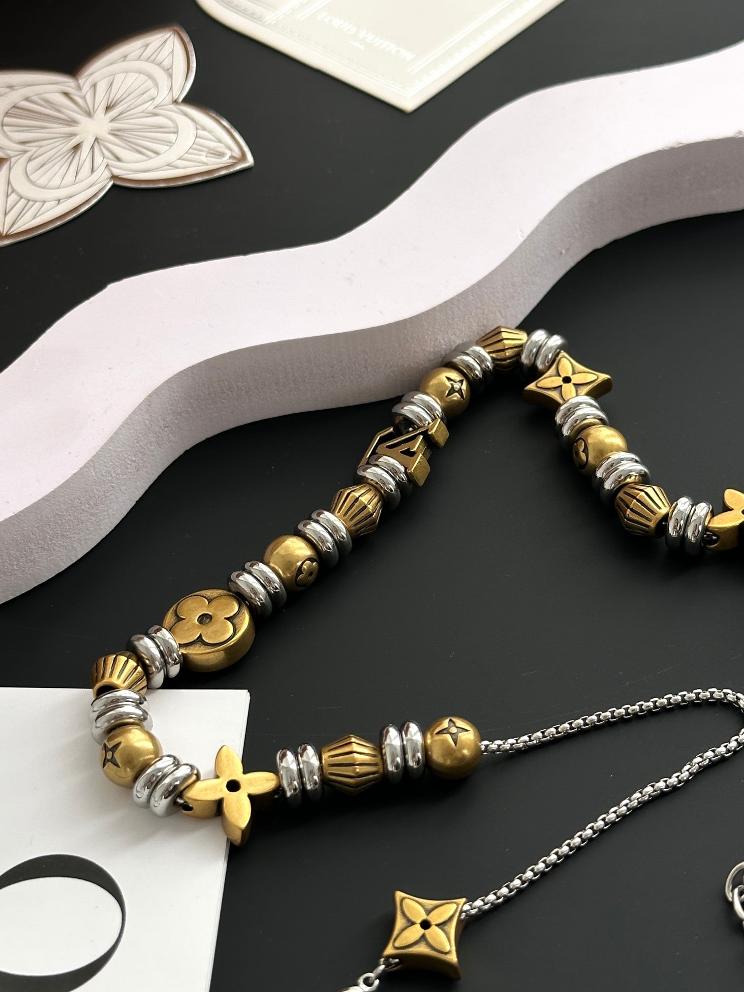 Louis Vuitton beaded bracelet and charm necklace with gold star pendant