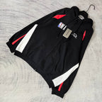 Balenciaga black zip-up hoodie with diagonal white panels and red side accents