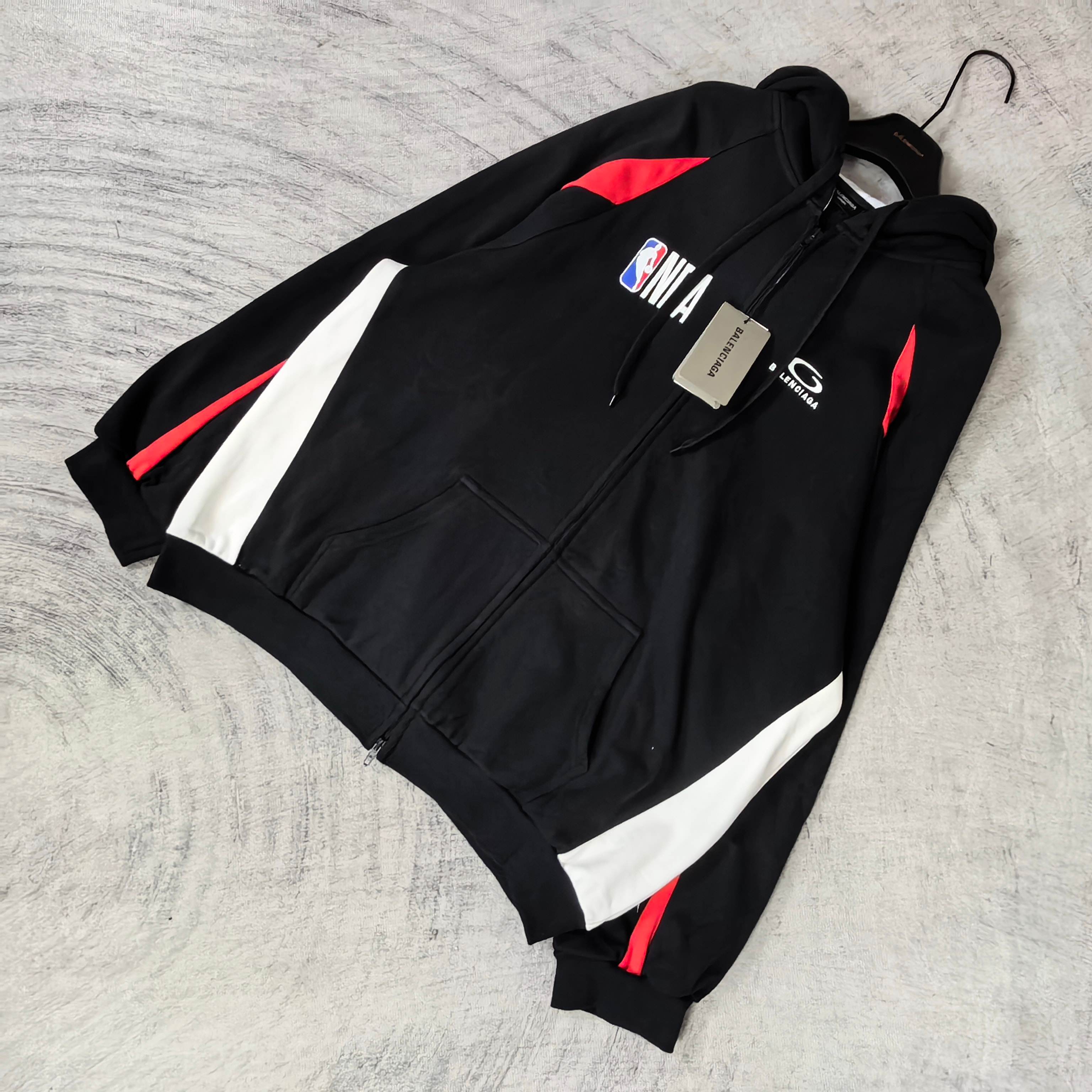 Balenciaga black zip-up hoodie with diagonal white panels and red side accents
