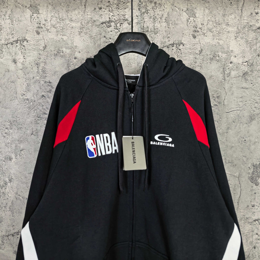 Balenciaga black zip-up hoodie with NBA logo, hood drawstring, and red shoulder graphic