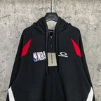 Balenciaga black zip-up hoodie with NBA logo, hood drawstring, and red shoulder graphic