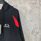 Balenciaga sleeve logo patch on black zip-up hoodie with red triangle