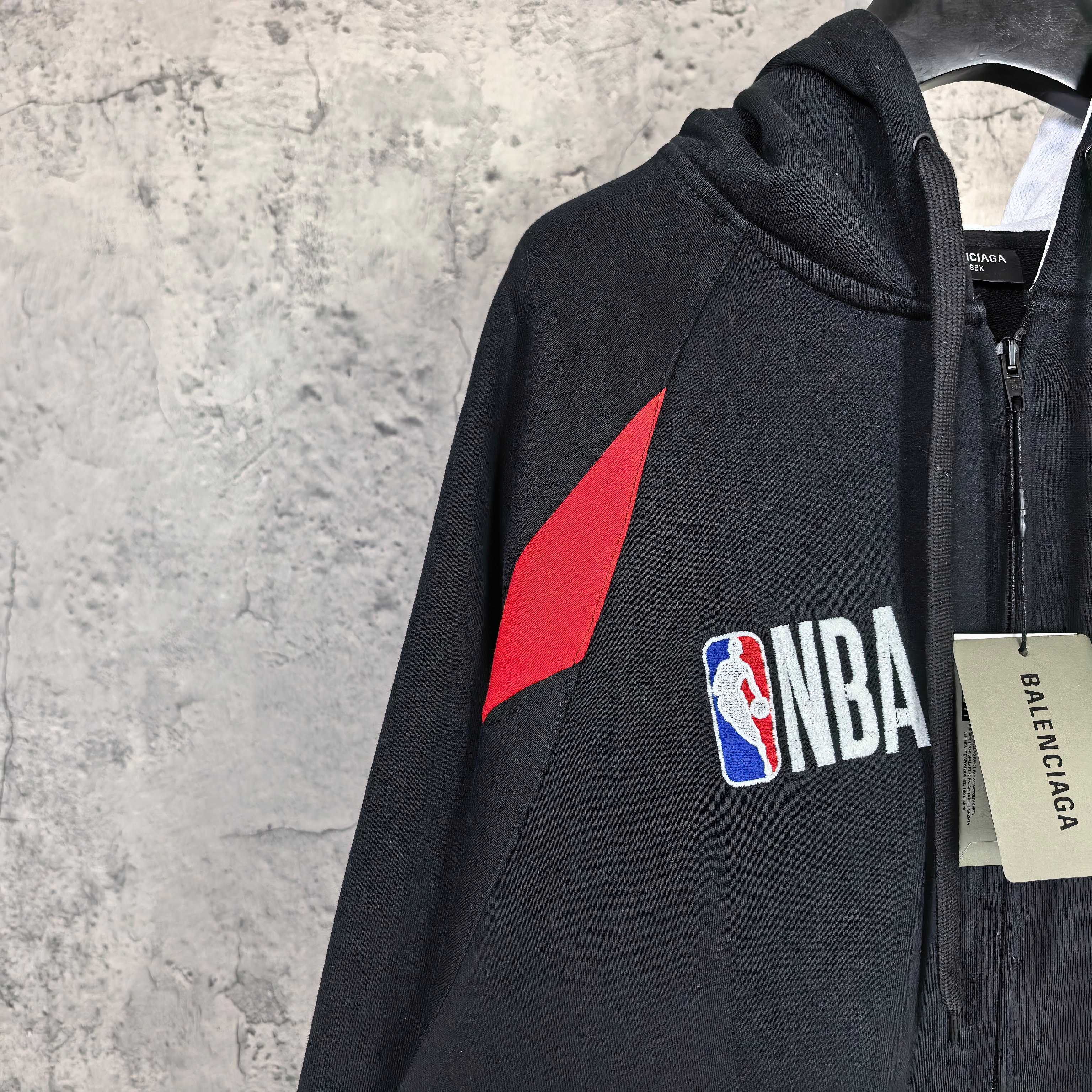 Balenciaga black zip-up hoodie with red triangle graphic and NBA logo patch