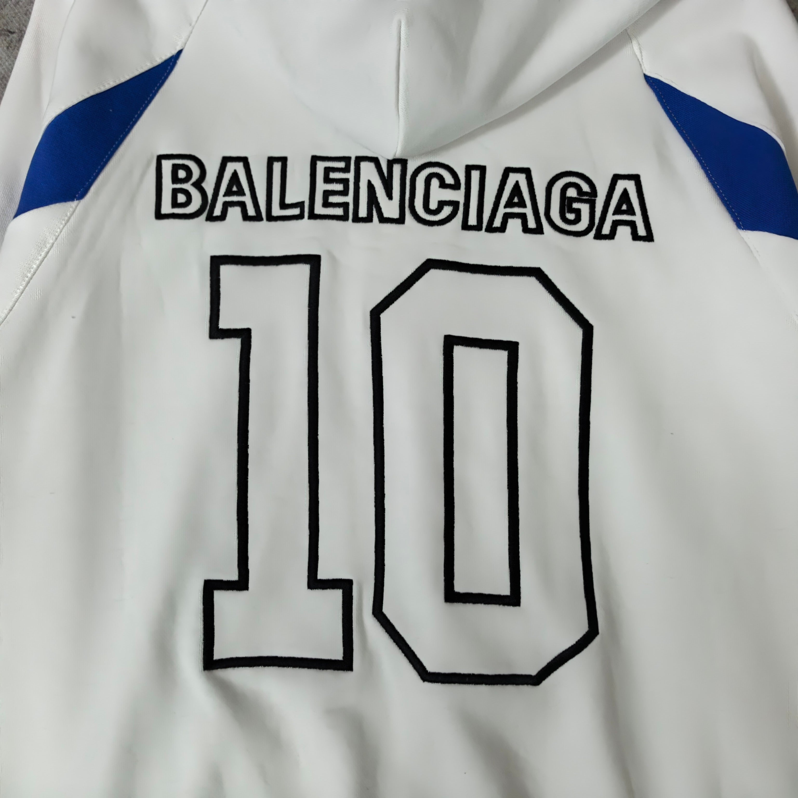 Balenciaga hoodie detail: '10' number print with Balenciaga text and blue shoulder accents