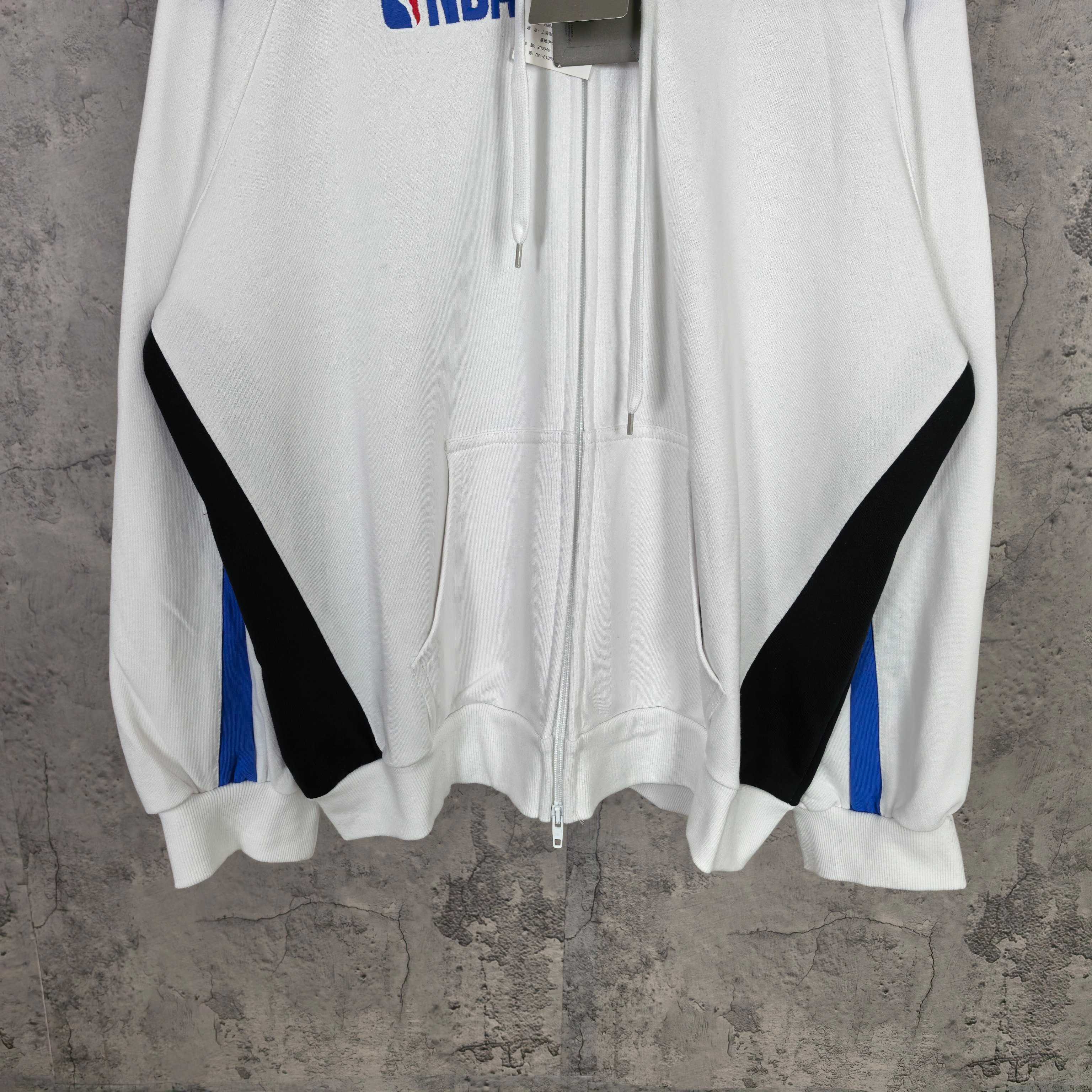 Balenciaga long zip-up hoodie front view, white with black diagonal panels