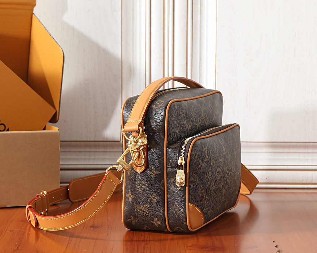 Monogram crossbody bag side view with adjustable strap and gold-tone hardware