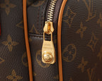 Louis Vuitton logo zipper pull on monogram bag with tan leather trim