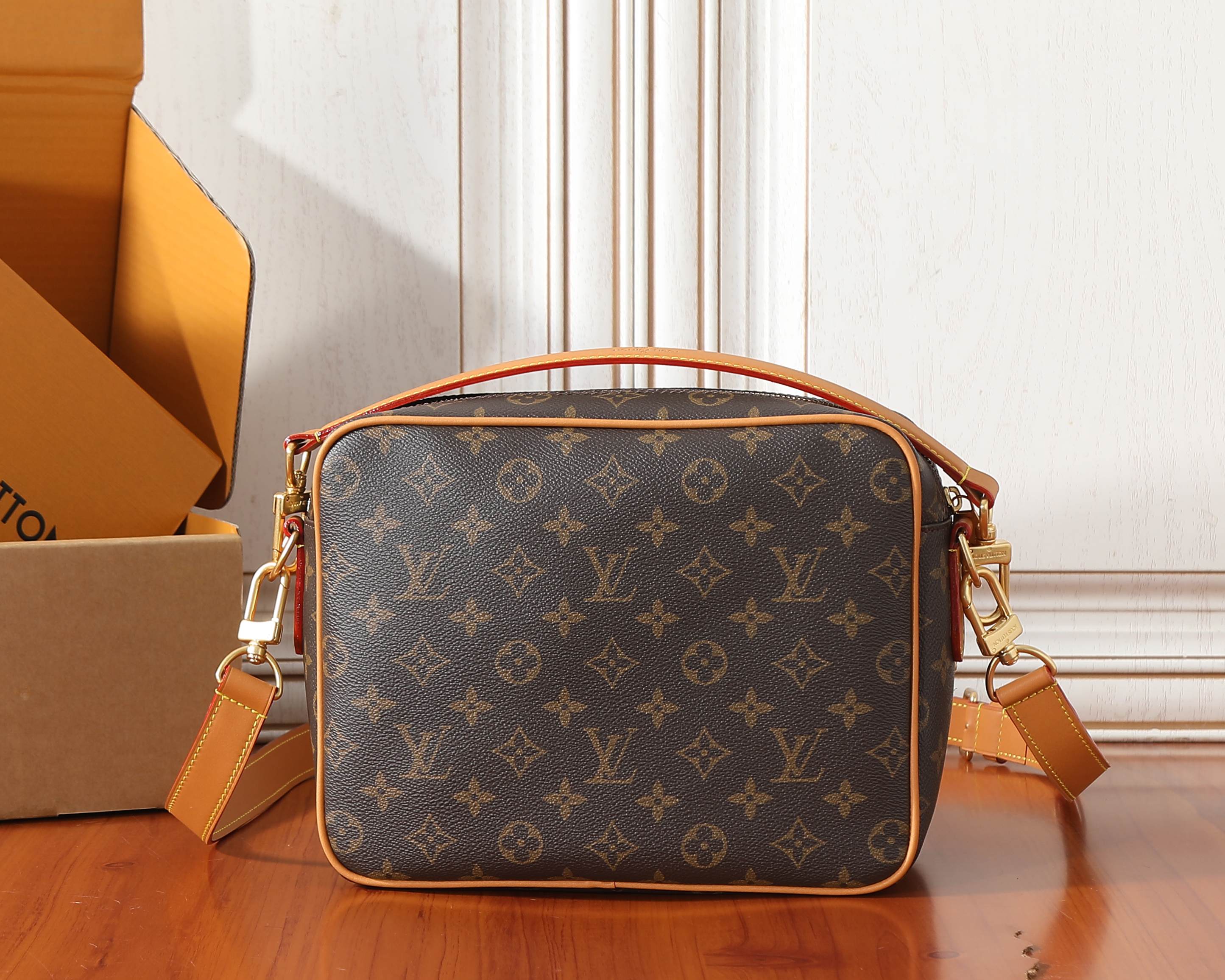 Monogram crossbody bag front view with gold-tone hardware and top handle