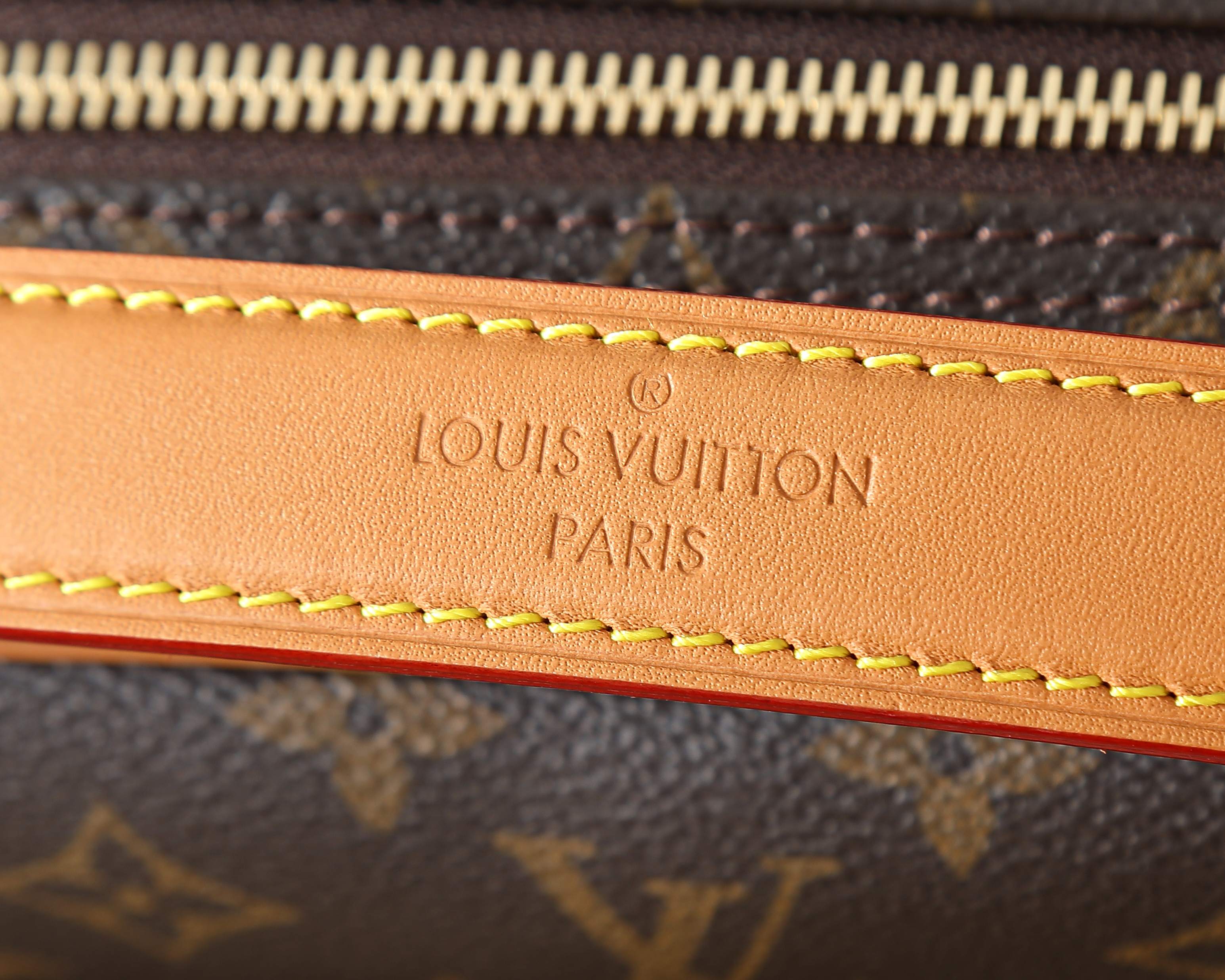 Louis Vuitton Paris stamped leather trim with contrast tan-and-red stitching
