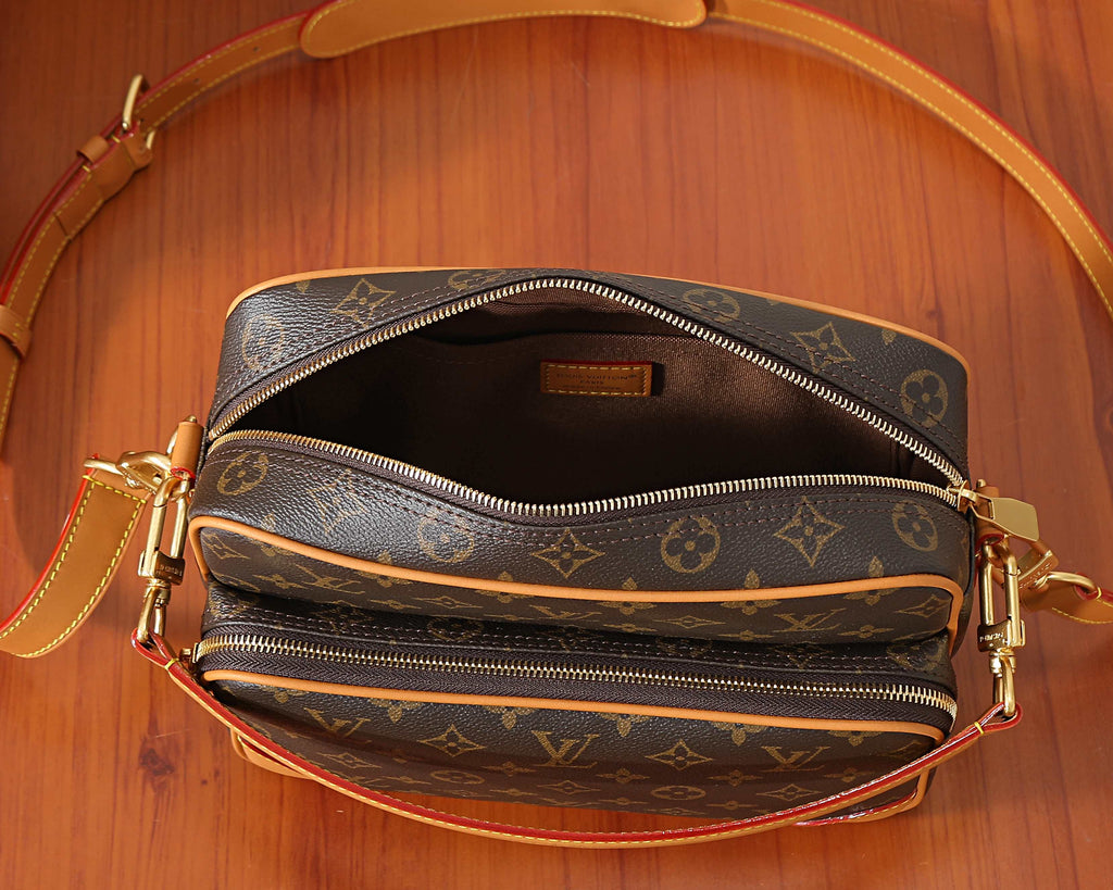 Monogram crossbody bag interior view with two zip compartments and tan lining