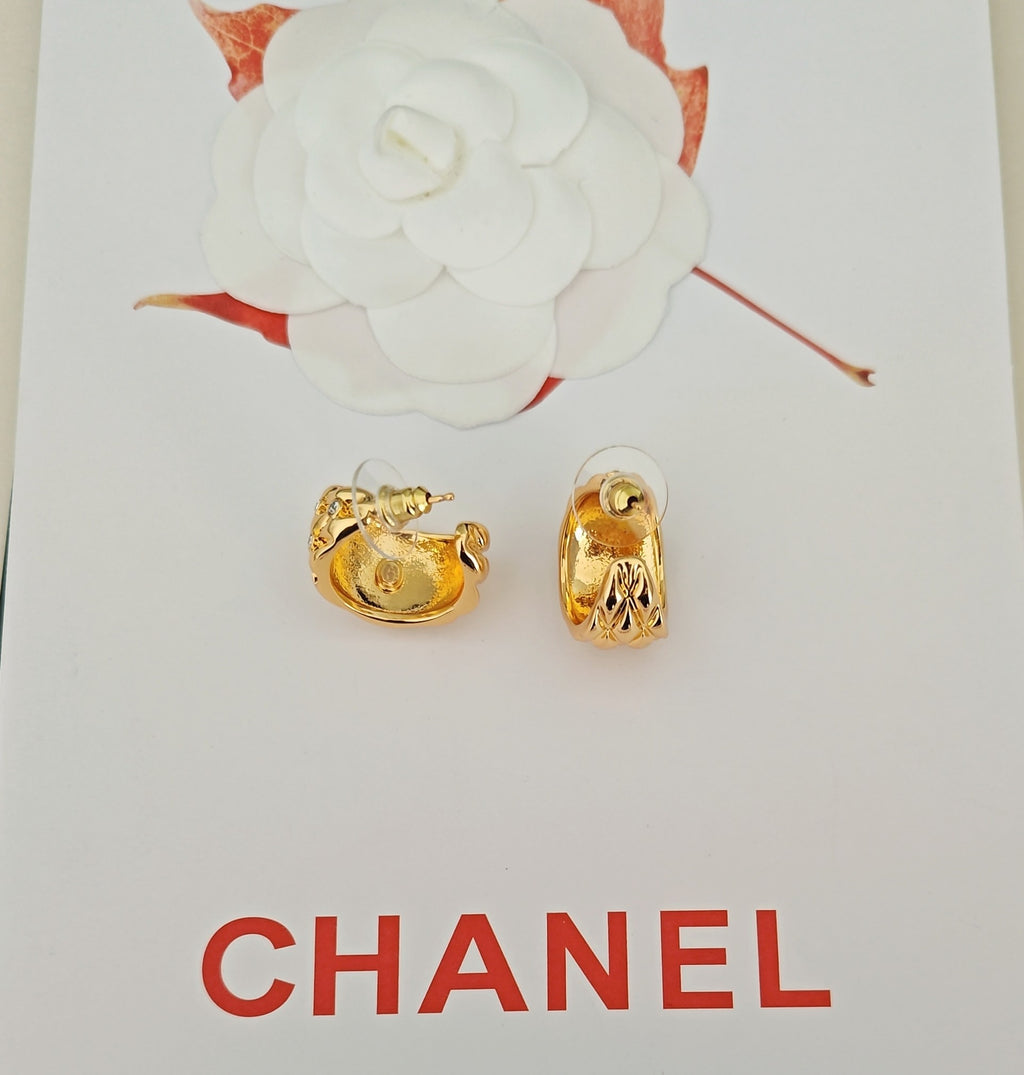 Gold-tone earrings with crystal-like details, shown as a pair