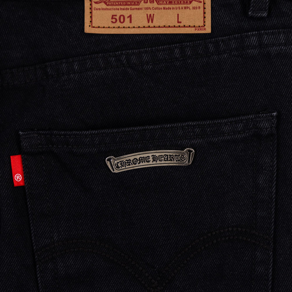 Black denim pants coin pocket area with stitched pocket details