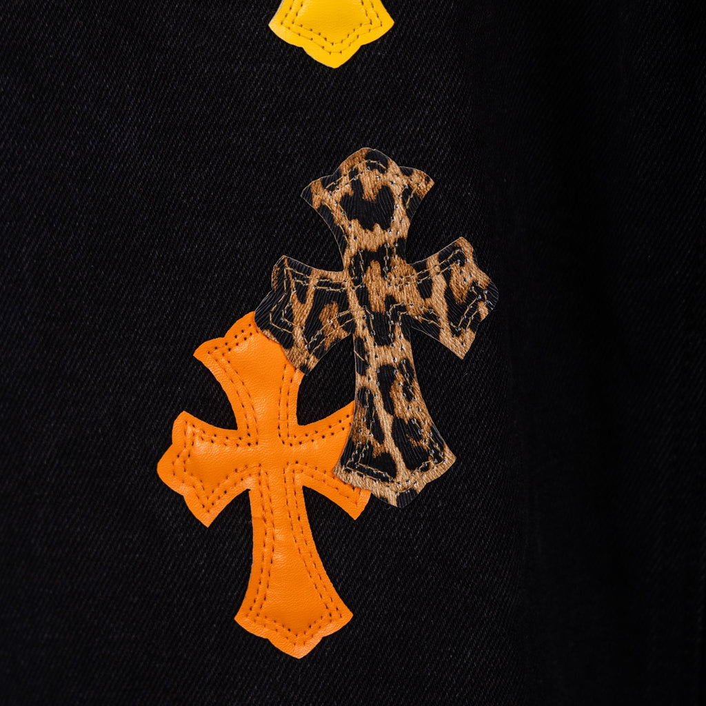 Black denim pants with leopard and orange cross appliqué patches