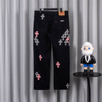 Black denim pants with pink and checkered cross patches, back view.